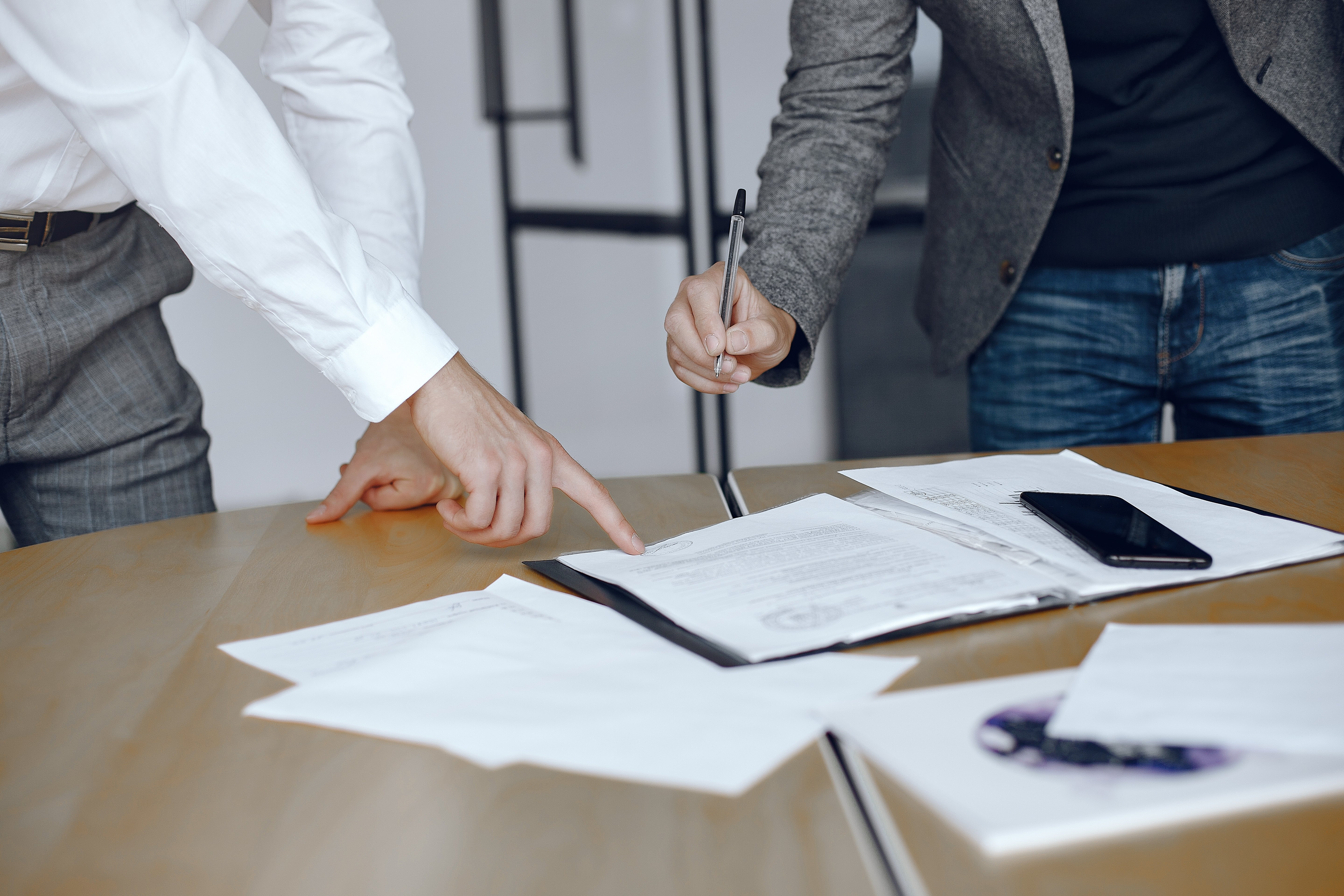 Two business partners signing a document